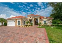 Beautiful one-story home with tile roof, paver driveway & landscaping at 8074 Wiltshire Dr, Port Charlotte, FL 33981