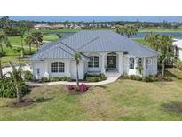 Single-Gathering home with metal roof and manicured lawn at 495 Coral Creek Dr, Placida, FL 33946