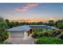 House with solar panels and landscaped yard at 120 Barracuda Dr, Placida, FL 33946