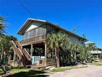 Elevated beach home with screened porch and wooden deck at 8934 Gulf St, Placida, FL 33946