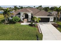 Single-Gathering home with a 2-car garage and lush landscaping at 15390 Ancel Cir, Port Charlotte, FL 33981