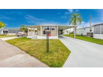 Tan mobile home with carport and mailbox at 337 Blackburn Blvd, North Port, FL 34287