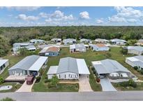 Aerial view of a 55+ community with lush landscaping and various mobile homes at 726 Watersedge St, Englewood, FL 34223