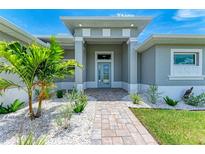 Elegant front entry with a light blue door and stone pathway at 9293 Panama Cir, Port Charlotte, FL 33981