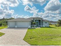 Single-Gathering home with three car garage and paver driveway at 14999 Wichita Rd, Port Charlotte, FL 33981