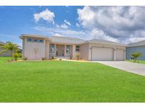 New construction home with a two-car garage and lush lawn at 8343 Olsen St, Port Charlotte, FL 33981