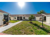 Two-unit building with landscaping and walkways at 6796 Gasparilla Pines Blvd # 95, Englewood, FL 34224