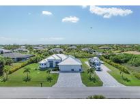 Aerial view of a beautiful home with a large driveway and RV parking at 14207 Union Hall Ave, Port Charlotte, FL 33981