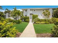 Gray building with lush landscaping and stairs at 5850 Gasparilla Rd # M1&3, Boca Grande, FL 33921