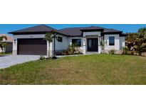 Modern home exterior with a dark gray roof and light-colored walls at 10401 Sunday Dr, Port Charlotte, FL 33981