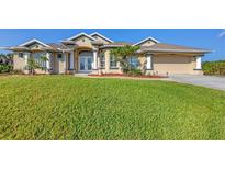 Beautiful two-story home with a large yard, manicured lawn, and attached garage at 14091 Peekskill Ave, Port Charlotte, FL 33981
