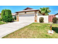 Single-story home with attached garage and landscaped yard at 570 Foxwood Blvd # 196, Englewood, FL 34223