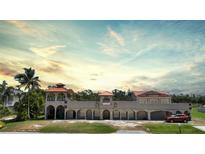 Mediterranean style home with terracotta roof and multiple garages at 14234 River Beach Dr, Port Charlotte, FL 33953
