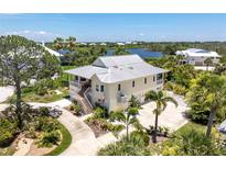 Charming home with metal roof, landscaped yard, and spacious driveway at 13074 Via Flavia, Placida, FL 33946