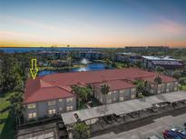 Aerial view of condo building with parking and water view at 23465 Harborview Rd # 1021, Punta Gorda, FL 33980