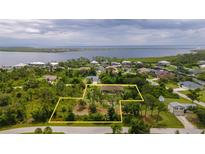 Aerial view of a single-Gathering home with a large lot and waterfront access at 4233 Reynolds Ln, Port Charlotte, FL 33981