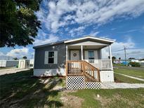 Charming single-Gathering home with a welcoming porch and well-maintained front yard at 1377 Ibis Dr, Englewood, FL 34224