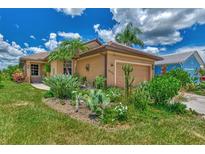 Well-maintained house with a landscaped front yard and a two-car garage at 3275 Osprey Ln, Port Charlotte, FL 33953