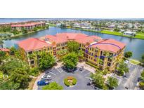 Waterfront condo building with terracotta roofs and balconies at 94 Vivante Blvd # 402, Punta Gorda, FL 33950