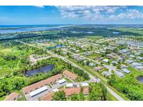 Aerial view of a community with waterfront access and lush landscaping at 6796 Gasparilla Pines Blvd # 48, Englewood, FL 34224