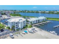 Aerial view of waterfront community with boat slips and lush landscaping at 7070 Placida Rd # 1221, Placida, FL 33946