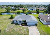 An aerial view of a single-story house with a large yard at 189 Bunker Rd, Rotonda West, FL 33947