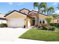 Charming single Gathering home featuring an attached two car garage, manicured lawn, and tasteful landscaping at 1012 Bradberry Dr, Nokomis, FL 34275
