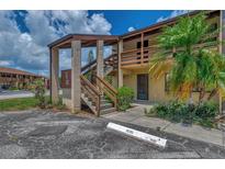 Exterior view of building with stairs and landscaping at 6 Quails Run Blvd # 7, Englewood, FL 34223