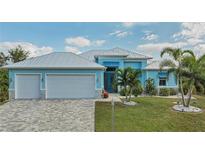 Stunning light blue home with a metal roof and spacious driveway at 10136 Amy Ter, Port Charlotte, FL 33981