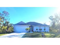 Two-story home with a white exterior, gray roof, and a two-car garage at 9174 Bensonhurst Ln, Englewood, FL 34224