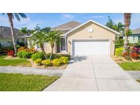 One-story house with two-car garage and landscaping at 417 Tomoka Dr, Englewood, FL 34223
