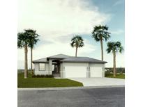 Single-story home with three-car garage and palm trees at 9309 Zorn St, Port Charlotte, FL 33981