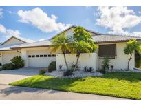 Front view of a charming house with well-maintained landscaping and a garage at 101 Pebble Rock Dr, Venice, FL 34293