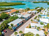 Aerial view of waterfront community with various houses and lush greenery at 2375 N Beach Rd # 3A, Englewood, FL 34223