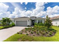 Beautiful house with a landscaped yard and paved driveway at 9982 Beachwalk Dr, Englewood, FL 34223