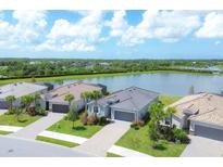 Aerial view of a waterfront community featuring new homes with modern architecture and landscaping at 14589 Ponce De Leon Trl, Port Charlotte, FL 33981