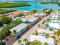 Aerial view of waterfront community with houses and lush landscaping at 2375 N Beach Rd # 3B, Englewood, FL 34223