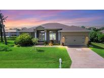 Single-Gathering home with landscaped lawn and attached garage at 249 Rotonda Cir, Rotonda West, FL 33947