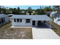 Charming single-story home featuring a new roof, covered carport, and freshly painted exterior at 317 E Green St, Englewood, FL 34223