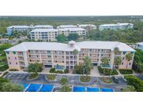Aerial view of a condo building with parking and landscaping at 8403 Placida Rd # 303, Placida, FL 33946