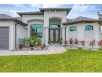 Modern two-story home with attractive landscaping at 15424 Lakeland Cir, Port Charlotte, FL 33981