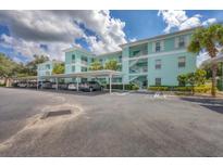 Condo building with covered parking and landscaping at 19385 Water Oak Dr # L-106, Port Charlotte, FL 33948