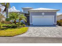 Two-car garage and front entrance of charming home at 8769 Conch Ave, Placida, FL 33946