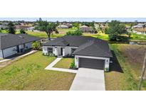 A charming single-Gathering home with a two-car garage and a well-manicured lawn near the canal at 220 Mark Twain Ln, Rotonda West, FL 33947