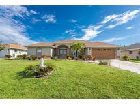 Single story home with landscaped yard and fountain at 240 White Marsh Ln, Rotonda West, FL 33947