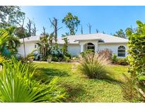 Single-Gathering home with lush landscaping and a spacious yard at 7171 Teaberry St, Englewood, FL 34224