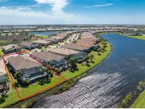 Aerial view of home with pool and canal views at 13077 Rinella St, Venice, FL 34293