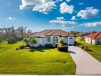 Single-story home with tile roof, driveway, and lush landscaping at 4130 Cape Haze Dr, Placida, FL 33946