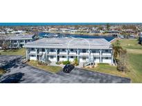 Aerial view of waterfront condo building with parking and boat slips at 150 Englewood Isles Pkwy # 206, Englewood, FL 34223