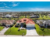 Aerial view of single Gathering home with red tile roof and canal views at 19 Sportsman Ln, Rotonda West, FL 33947